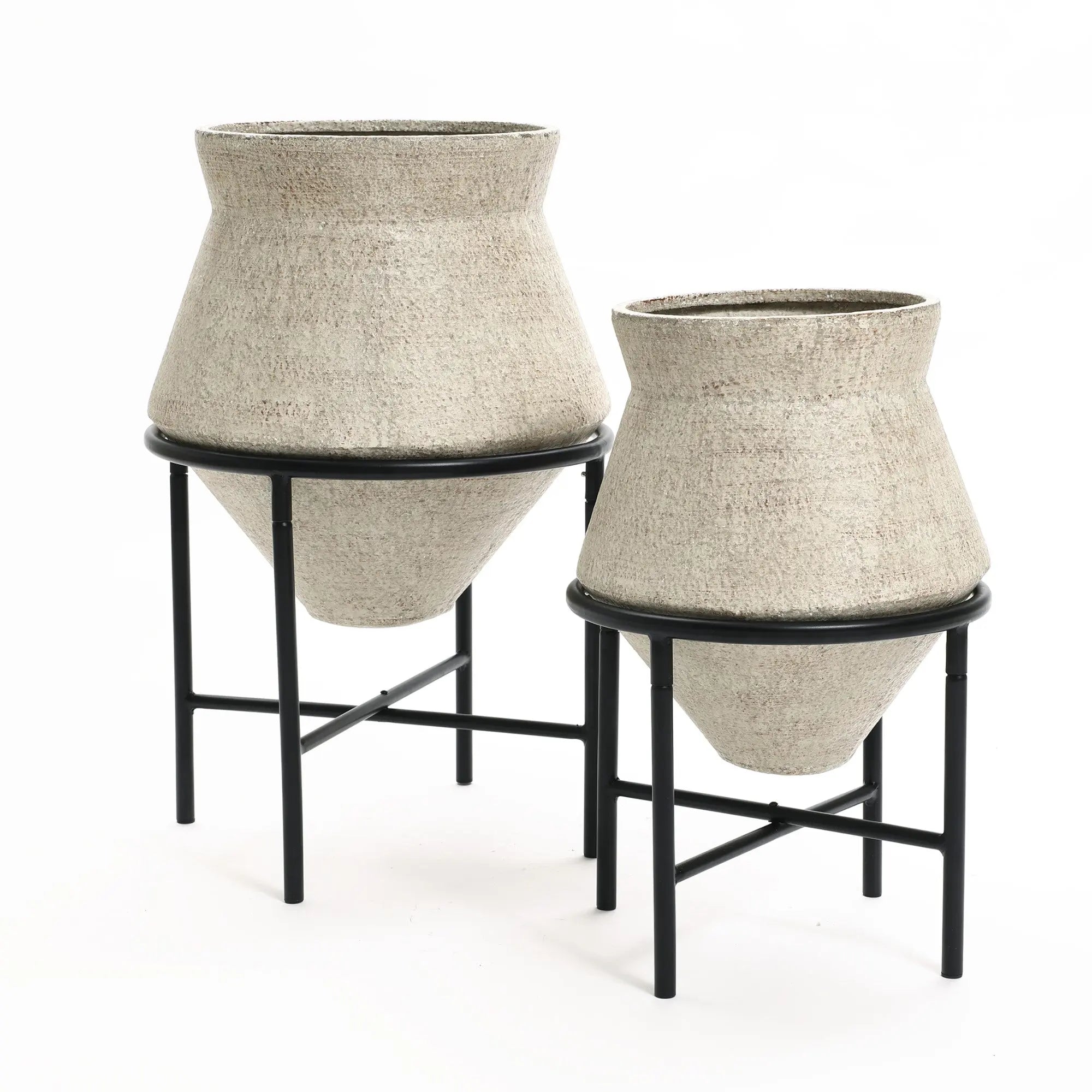 Two beige, textured cachepot planters on black metal stands, one larger than the other, add a touch of vintage distressed style against a white background. Perfect for elevating your indoor space decor with elegance and charm.