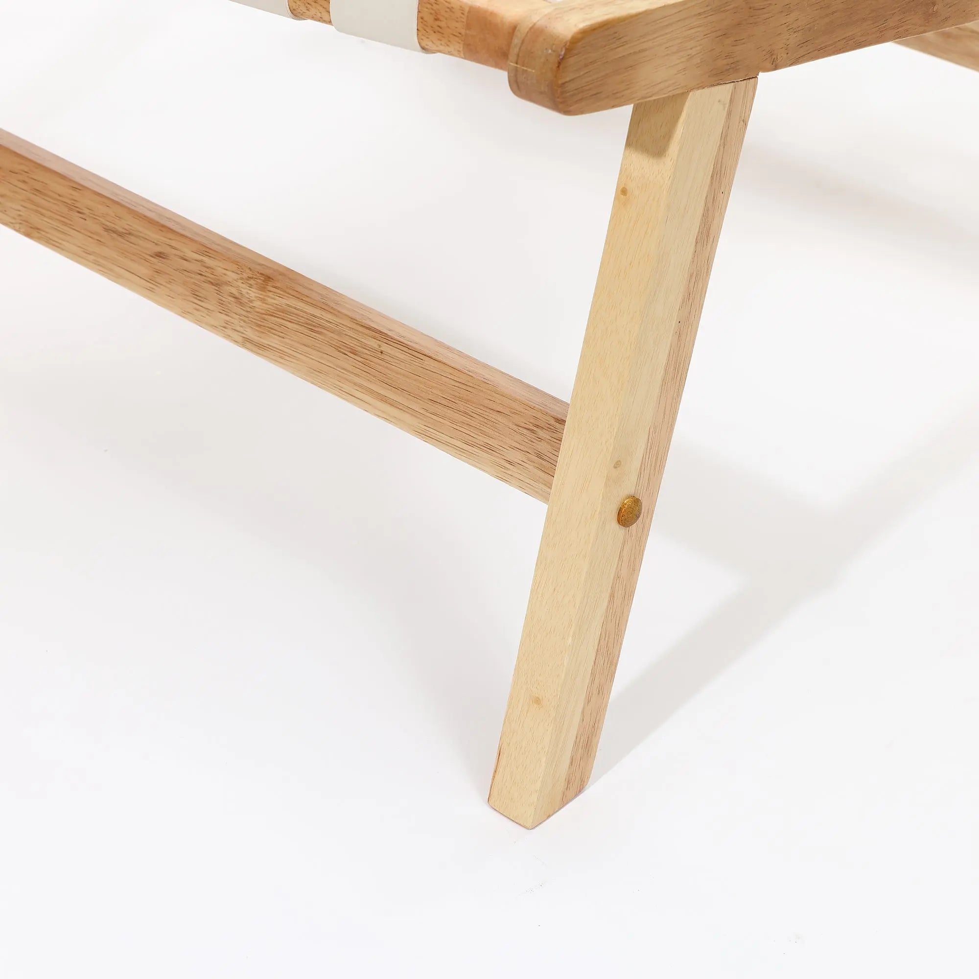 Close-up of wooden chair legs on a white background, showcasing a natural wood finish and simple construction, with solid wood frames highlighting its durability.