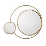 Two wall mirrors with golden frames, one larger and one smaller, are connected by a thin gold band, creating an abstract, overlapping design that exudes modern elegance.