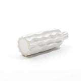 White ceramic sculpture resembling a cactus segment, lying horizontally on a plain white background, showcasing its elegant design.