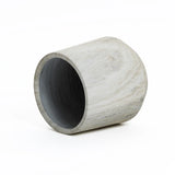 A gray, cylindrical concrete planter with a subtle marble ribbed texture lies on its side against a white background.