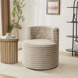 A modern living room showcases the LuxenHome Brie camel swivel barrel accent chair with a ribbed texture beside a wooden side table stacked with books. A framed abstract piece decorates the cream wall, while a black shelf and tall plant enhance the space.