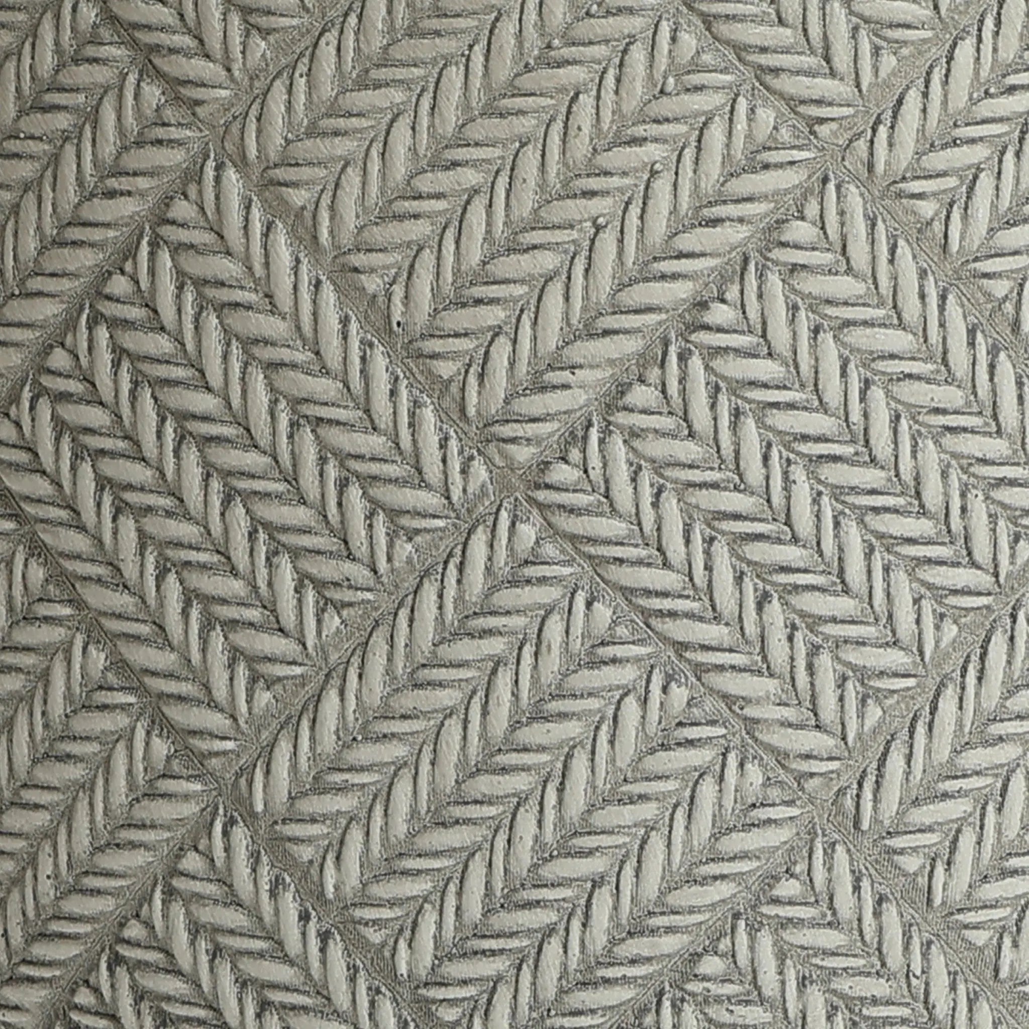 Close-up of an embossed pattern featuring diagonal rows of leaf-like shapes on a textured, three-dimensional MgO material surface. The design is arranged in a diamond grid formation, reminiscent of intricate planter aesthetics.