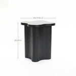 Black cloverleaf shape sculptural side table with a wavy-edge top, crafted from premium MDF wood, measuring 15.94 inches in diameter and 20.28 inches high, displayed against a white background.
