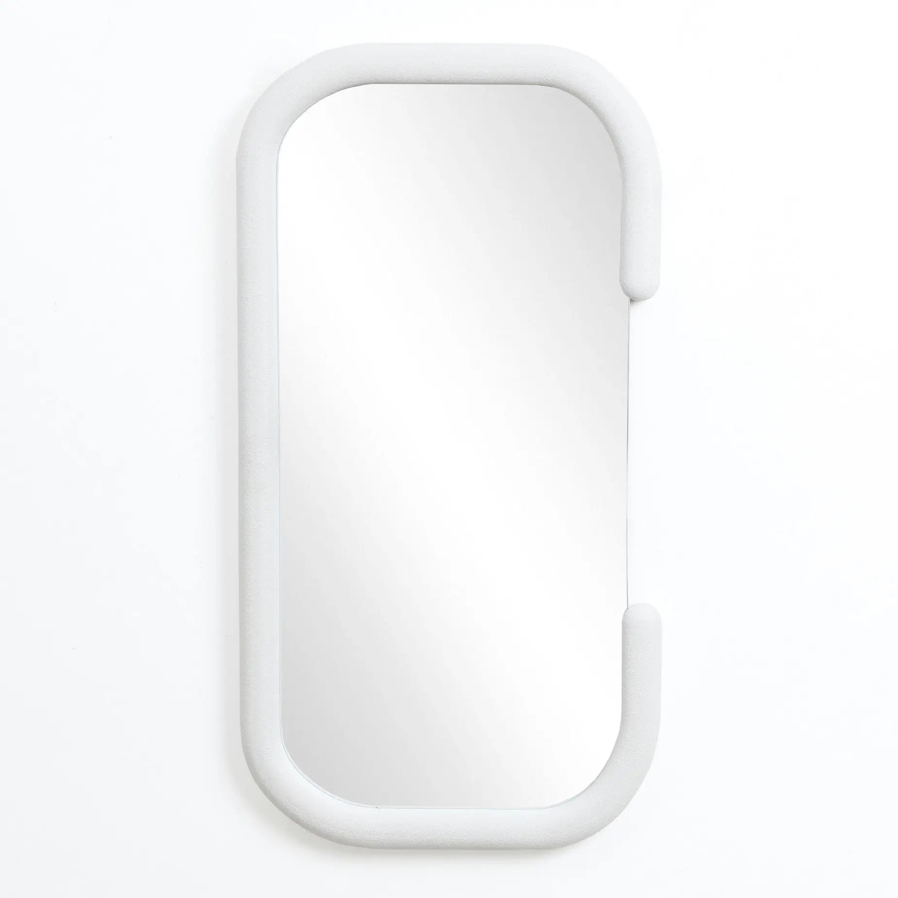 This decorative wall mirror features a modernist elegance with its rectangular form and rounded edges, all gracefully set within a sleek white oval frame, mounted on a plain white wall.