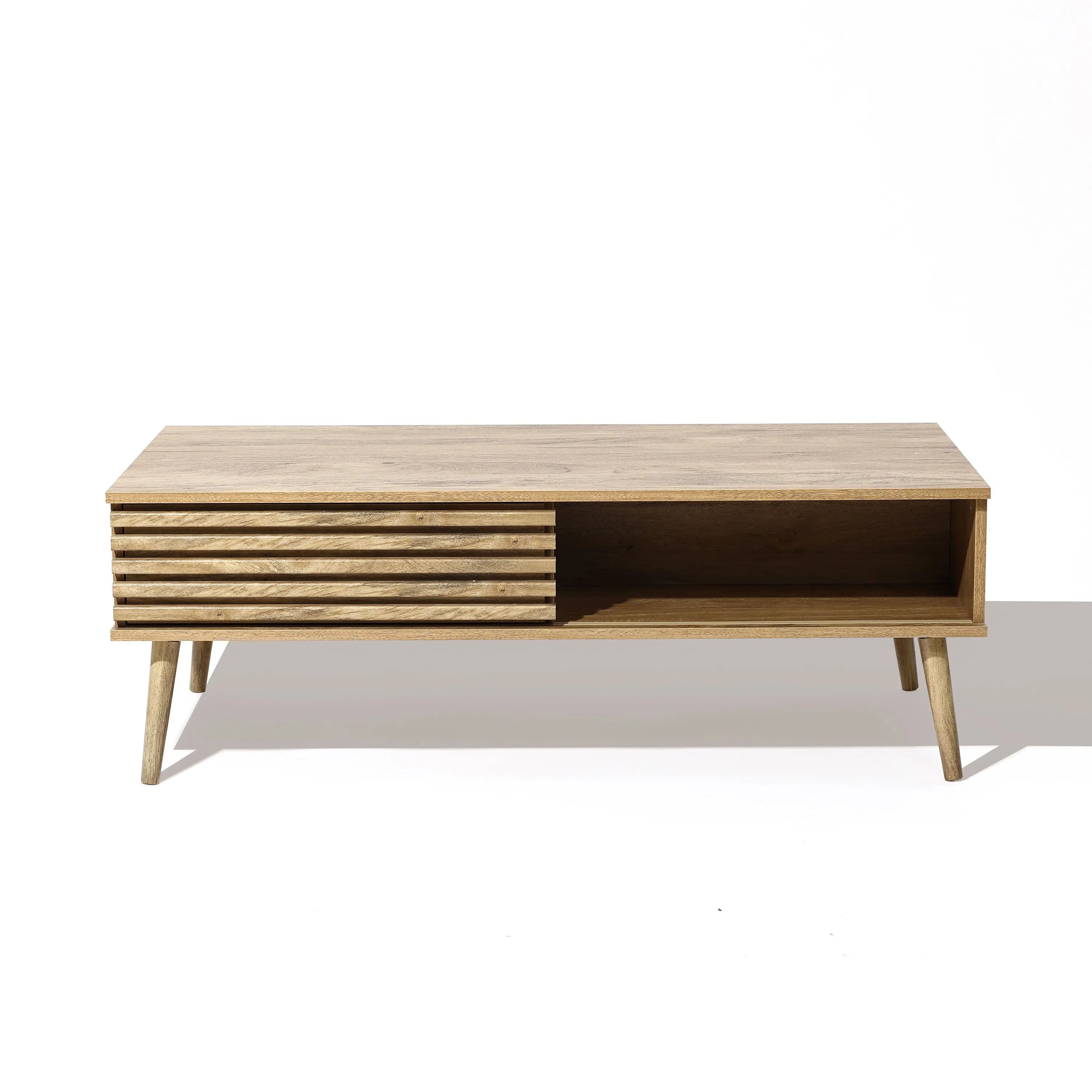 Wooden coffee table with angled legs, featuring sliding doors and a slatted front panel that reveals dual-side storage. Perfectly displayed on a white background, it offers both style and functionality.
