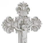 A white crucifix epitomizing Christian faith, showcasing a detailed depiction of Jesus, ornate designs, and a circular emblem with Latin inscriptions at the center. Perfect for religious occasions.