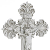 A white crucifix epitomizing Christian faith, showcasing a detailed depiction of Jesus, ornate designs, and a circular emblem with Latin inscriptions at the center. Perfect for religious occasions.