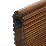 Close-up of the edge of a round tabletop with a grooved design, crafted from high-quality MDF wood, and featuring a black rubber cap on the corner.