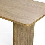 The LuxenHome Aria dining table, with smooth edges and a 63 wide tabletop, features a light wood grain finish that highlights its natural texture. Perfect for various decor styles, this rectangle table is ideal for 6 people and shown against a plain white backdrop.