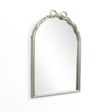 The Ribbon Wall Mirror features an elegant, arched silhouette with a decorative silver frame and a charming bow design atop, embodying a modern romantic style. Set against a plain white background, it effortlessly blends classic elegance with contemporary flair.
