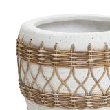 White textured planter with woven wicker accents in a crisscross pattern, exuding a Bohemian style charm.