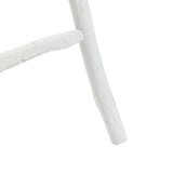 Close-up of a white wooden chair leg crafted from fir wood, showcasing a simple design with rustic charm.