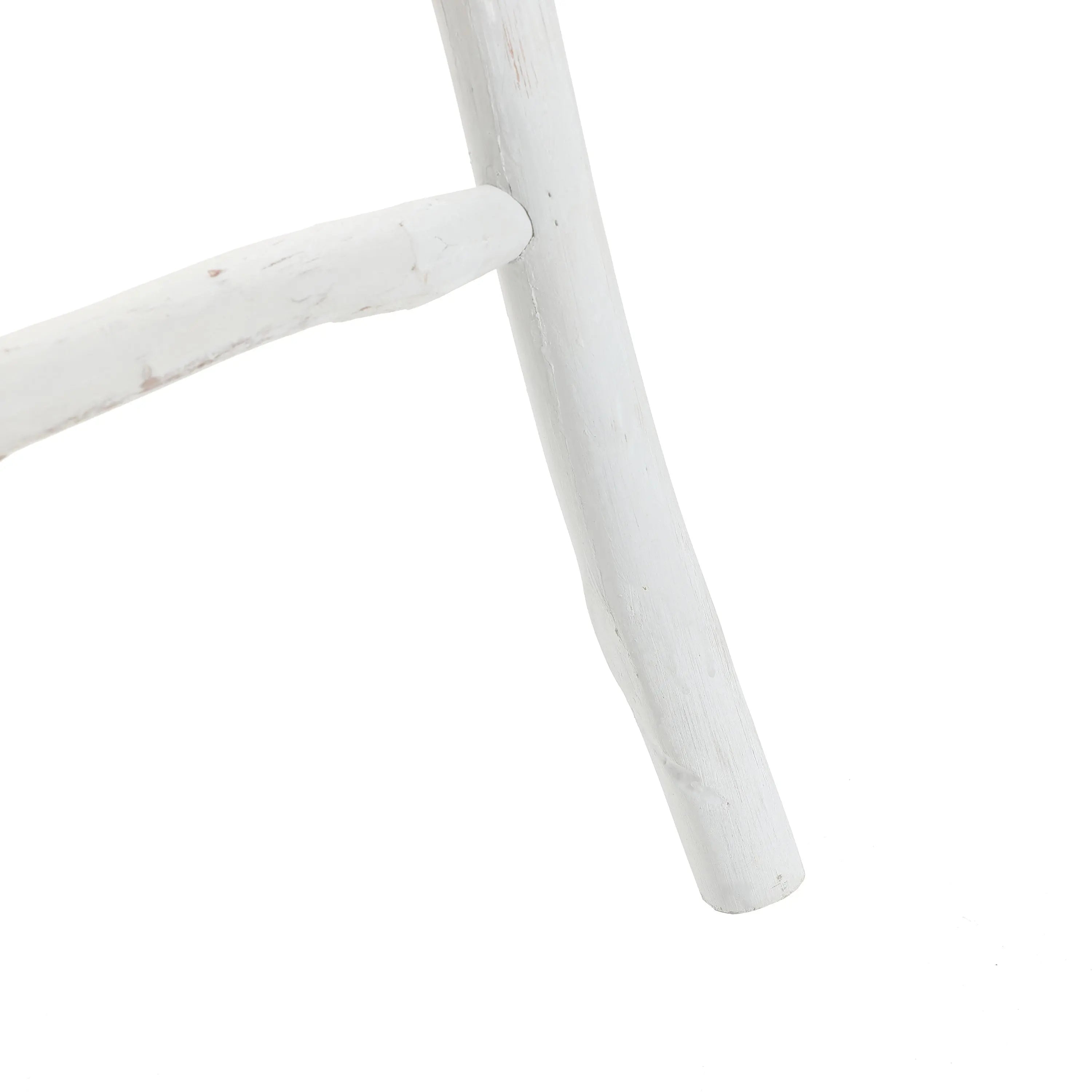 Close-up of a white wooden chair leg crafted from fir wood, showcasing a simple design with rustic charm.