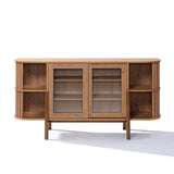 The LuxenHome Miko sideboard server cabinet showcases a mid-century modern design with two central sliding glass doors and open shelves on each side. Its oak grain texture adds a natural touch, while it stands on four solid wood legs.