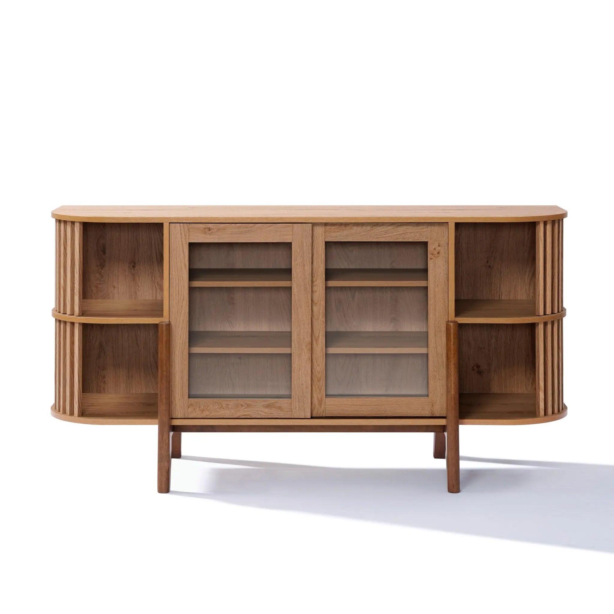 The LuxenHome Miko sideboard server cabinet showcases a mid-century modern design with two central sliding glass doors and open shelves on each side. Its oak grain texture adds a natural touch, while it stands on four solid wood legs.