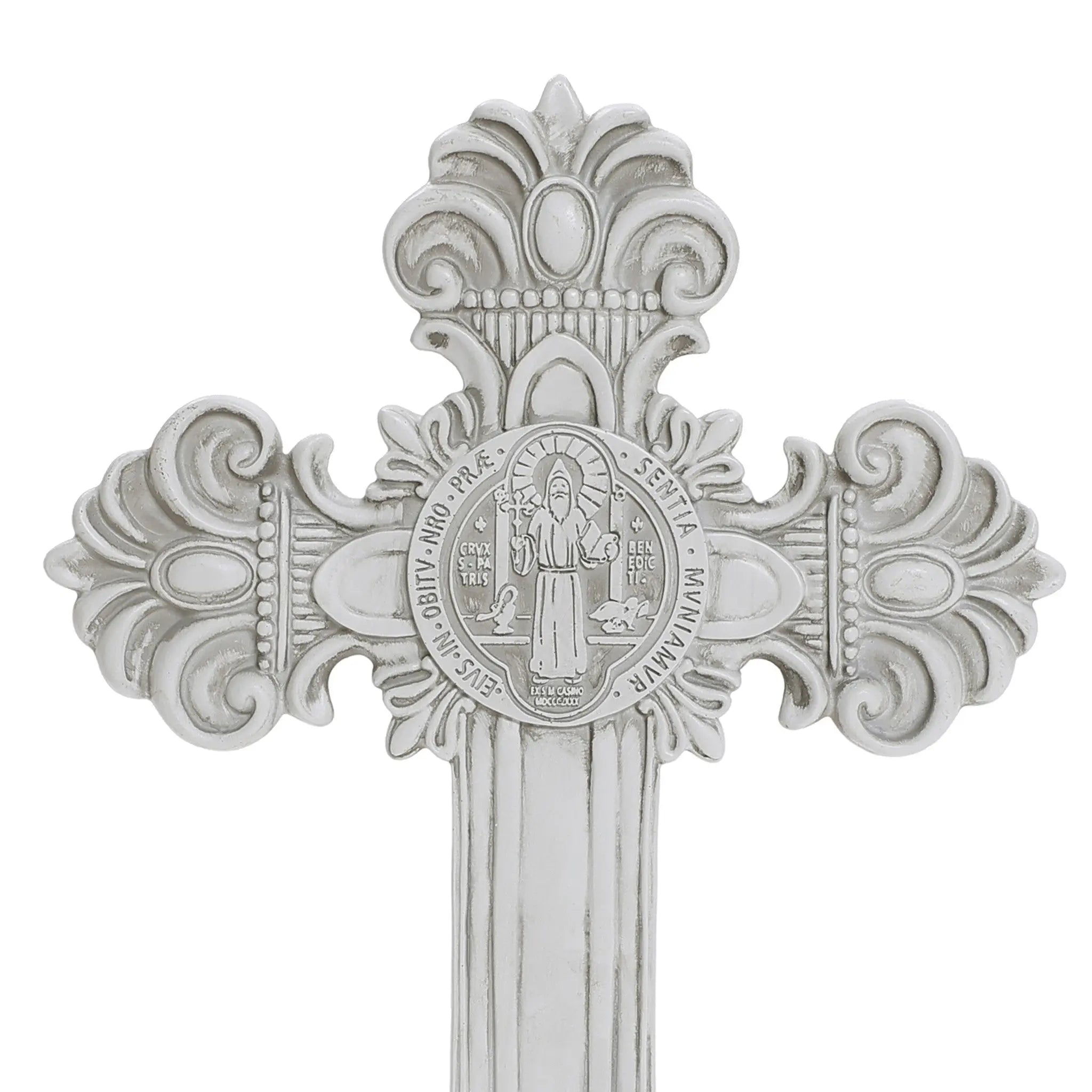 Silver decorative cross with ornate flourishes and an embossed image of a saint at the center, surrounded by inscriptions, perfect for celebrating religious occasions.