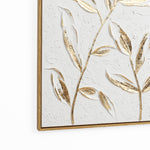 Textured wall art featuring a gold leaf motif on a white background, elegantly encased in a wooden frame for a modern wall decor statement.