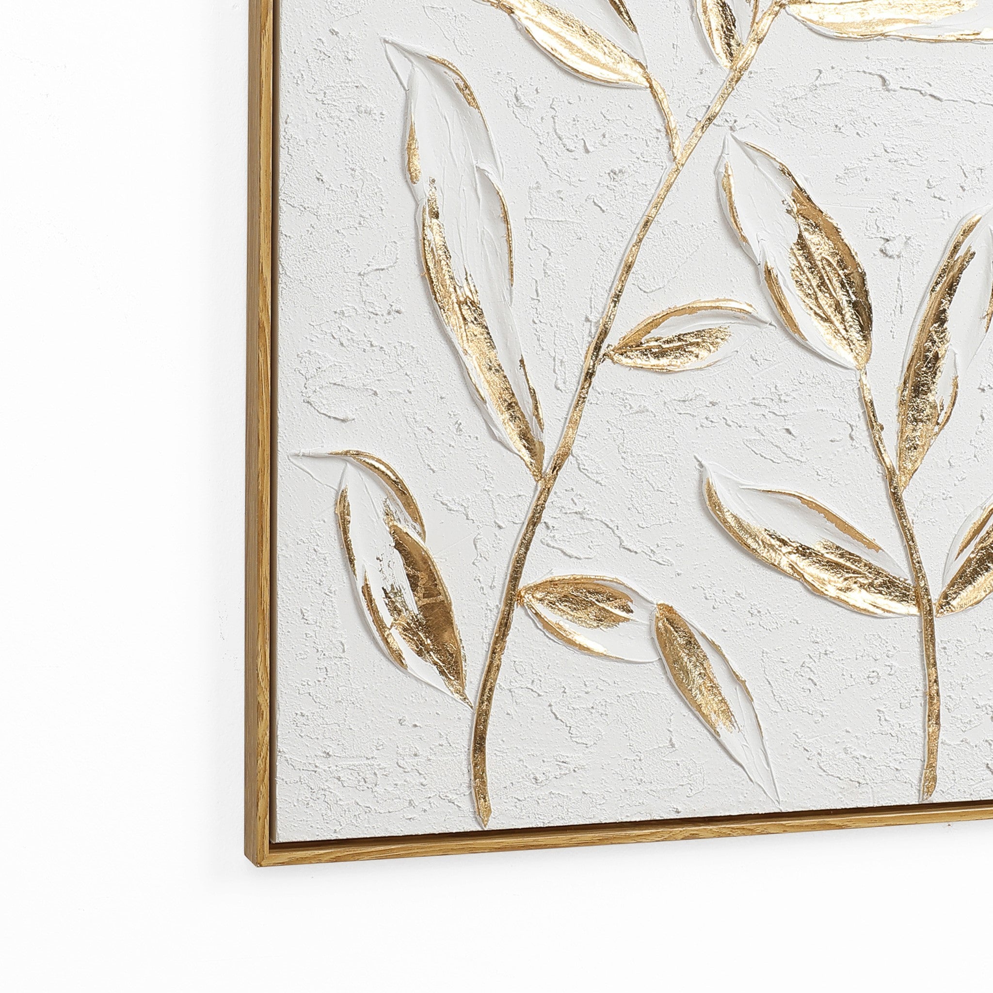 Textured wall art featuring a gold leaf motif on a white background, elegantly encased in a wooden frame for a modern wall decor statement.