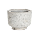 A round, speckled beige ceramic planter with a wide rim and short base exudes retro minimalist decor against a white background.