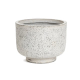 A round, speckled beige ceramic planter with a wide rim and short base exudes retro minimalist decor against a white background.