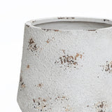 A textured, white ceramic pot with brown speckles and an unglazed rim, this round planter embodies a vintage minimalist style.