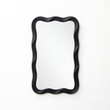 Modern wall mirror featuring a black, wavy, scalloped frame, mounted on a plain white wall.