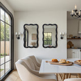 Two striking wavy frame mirrors on the wall. Enhancing the bright, contemporary space.