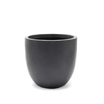 A matte black, round ceramic contemporary planter with a smooth surface sits on a white background.