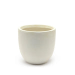 A plain, round, off-white ceramic contemporary planter with a smooth surface, placed against a white background.
