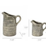 Two rustic pitcher vases, one large and one small, showcase artisanal craftsmanship with terracotta finish. The large vase is 8.66 tall and 7.48 wide, while the small stands at 5.51 tall and 5.91 wide, perfect for adding a touch of charm to any space.