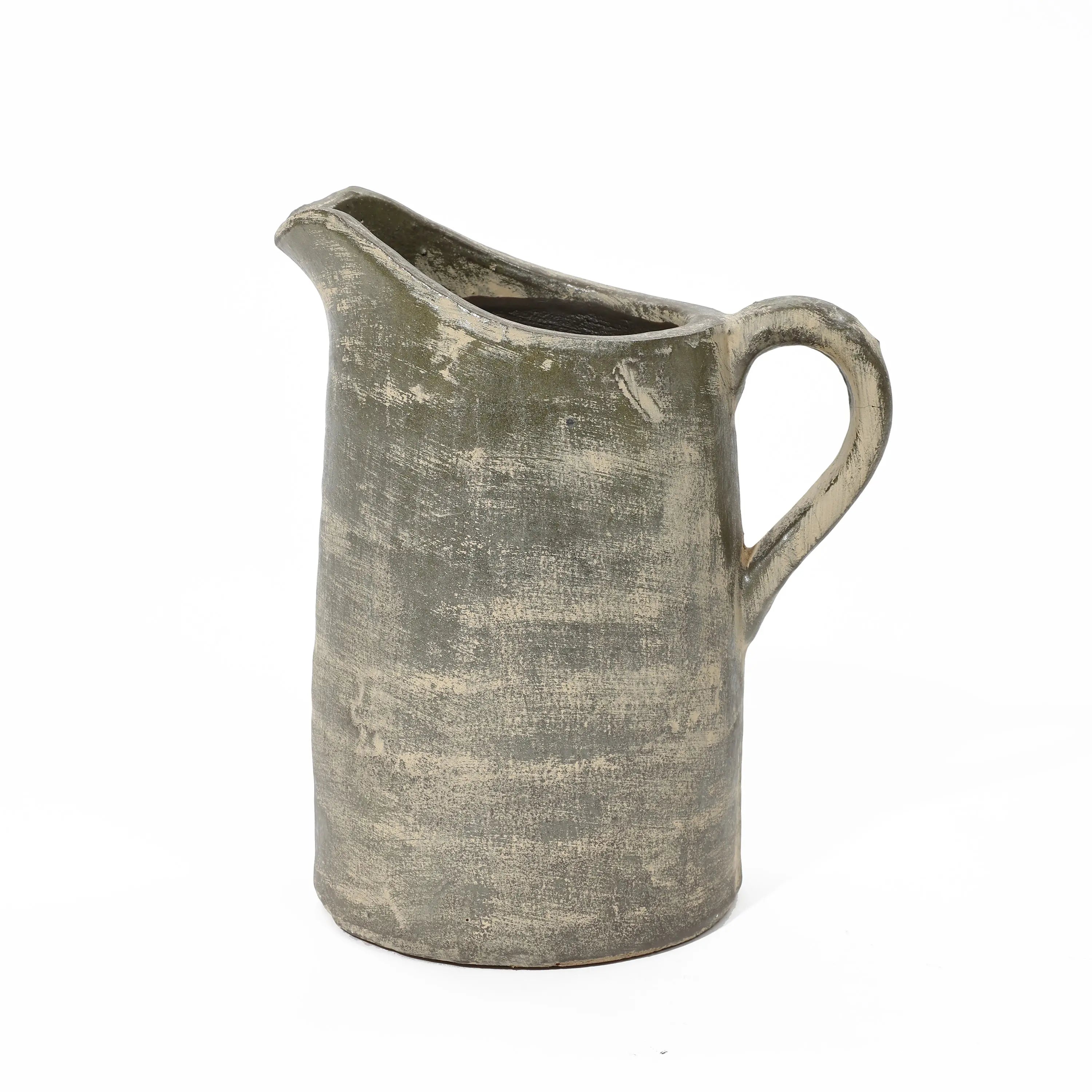 An artisanal craftsmanship shines through this rustic, textured ceramic pitcher with a handle, featuring an earthy, muted color and a terracotta finish.