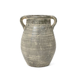 An aged, gray ceramic terracotta jug vase with a rounded body and two curved handles on either side, exuding historic depth through its handcrafted charm.