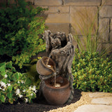 water-fountain-and-a-pot-in-a-garden-setting