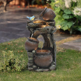 A decorative outdoor fountain with three rustic pots and a small blue bird, featuring water flowing from the top jar to the bottom, enhanced by LED lights, perfect for adding charm to your grassy lawn.