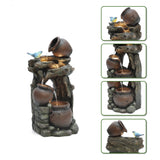 A tiered tabletop outdoor fountain with three rustic pots, faux wood and stone design, and a small blue bird figurine perched on the lowest jug. Four inset close-up views on the right highlight LED lights for added charm.