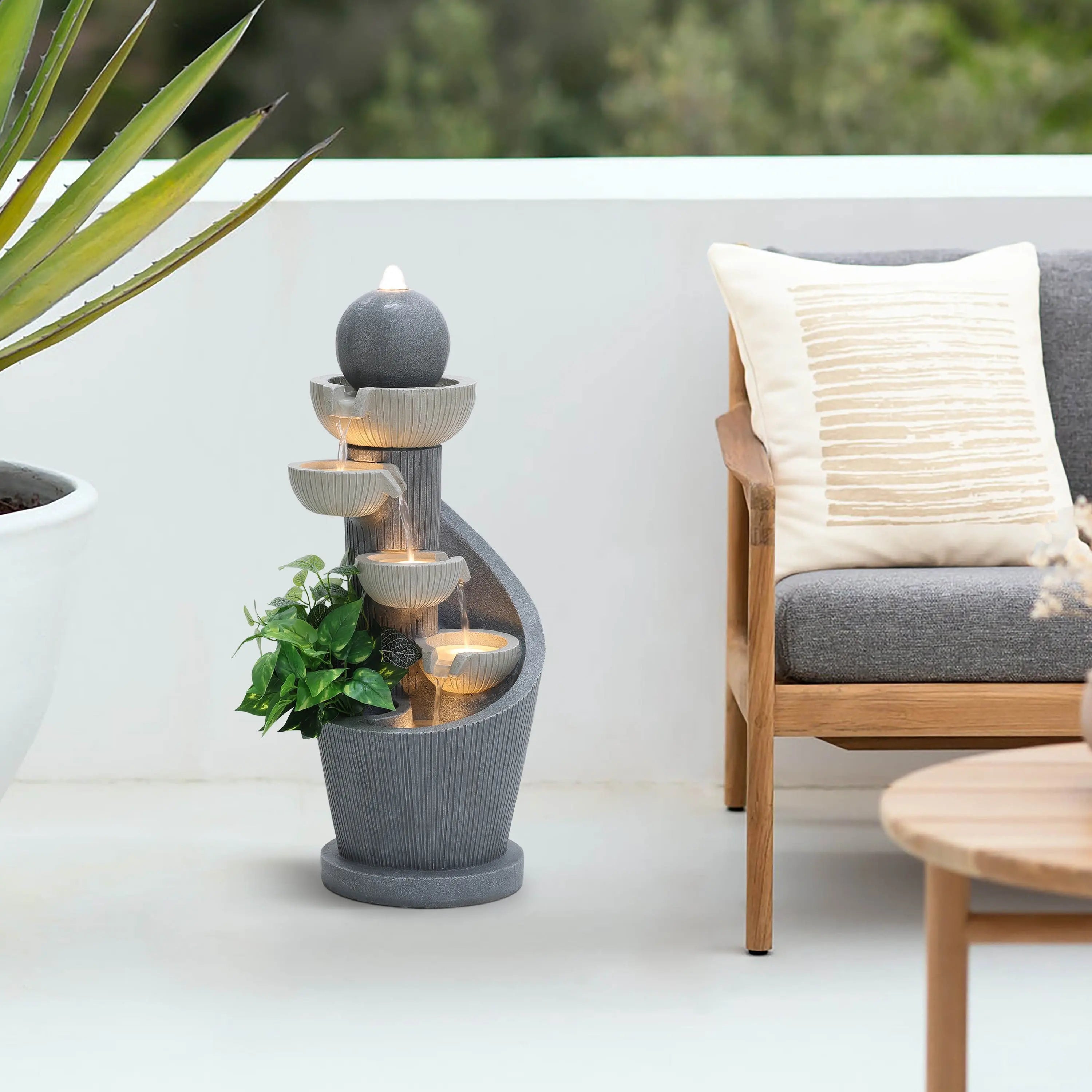 modern-style-cascading-fountain-with-led-lights-by-the-side-of-wood-outdoor-lounge-chair