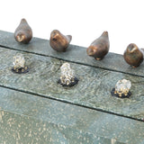 Four small bird sculptures sit atop this outdoor fountain, where three bubbling water features create the soothing sound of flowing water in a speckled green base—perfect for your patio or garden.