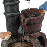 A close-up of a farmhouse outdoor fountain with two artificial birds perched on stone-like structures, water flowing gently through small basins, adding rustic charm to any space.