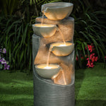 column shaped garden fountain with glowing lights in the bowls