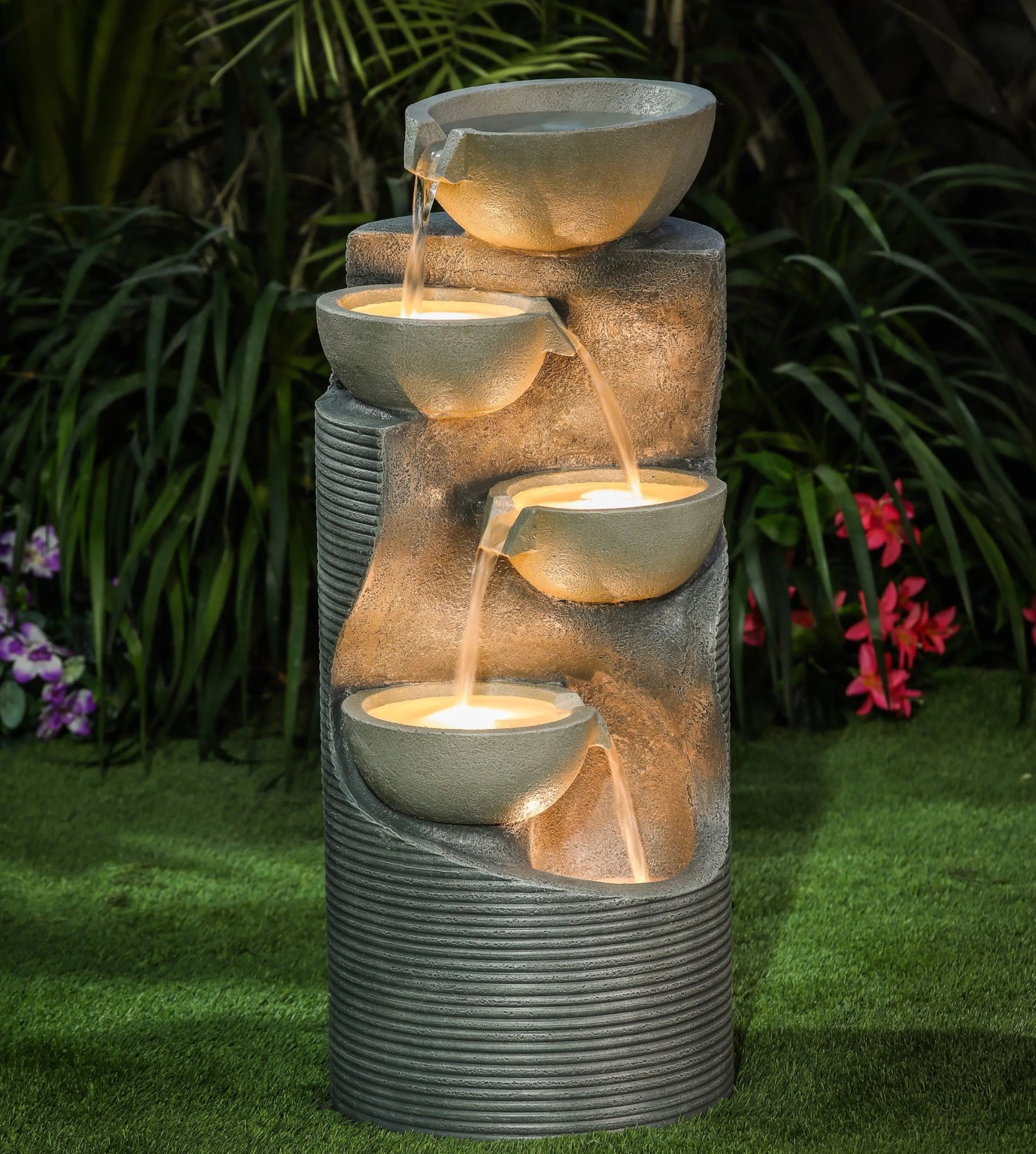 column shaped garden fountain with glowing lights in the bowls