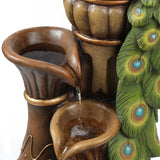 Close-up of a decorative outdoor fountain featuring brown basins and a green peacock feather design, perfect as garden décor, with water gently flowing between the basins.