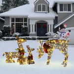 Three Deer Family Decorations with lights and red bows stand on a snowy lawn in front of a house adorned for winter, with an LED Holiday Decor snowman inflatable by the porch.