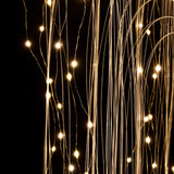 Thin strands of fiber optic cables with small white LED lights are shown glowing against a dark background.