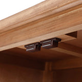 Close-up of the underside of a natural wood finish accent cabinet, showing two brown magnetic catches installed side by side.