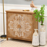 Wooden accent cabinet with a natural wood finish and white geometric leaf design, topped with decorative objects and flanked by two white vases and a small green plant.