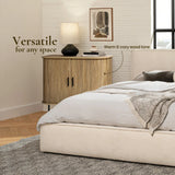 A bedroom with a beige bed, gray blanket, and a wooden nightstand featuring an oak grain finish. A lamp and abstract art sit on the nightstand against a white brick wall. Text reads Versatile for any space.