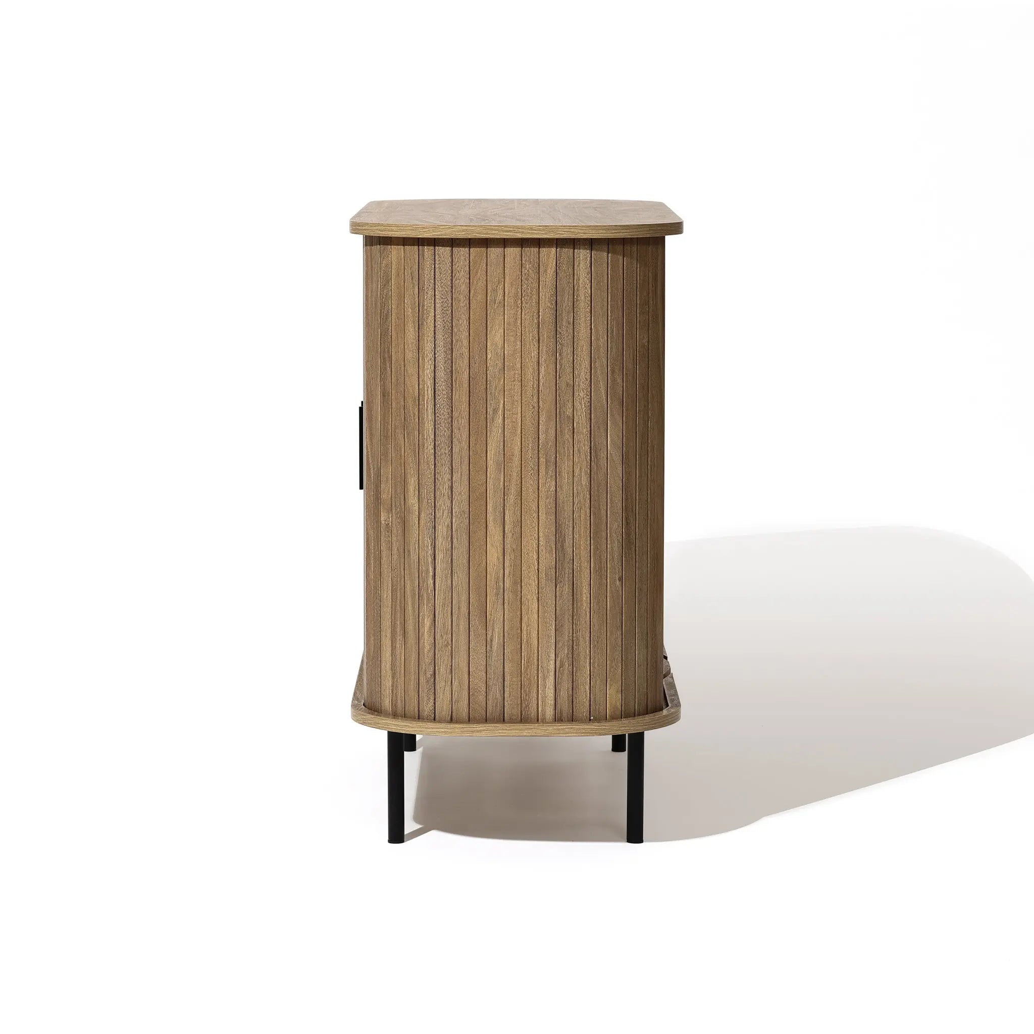 Mid-Century Modern Accent Cabinet featuring a stylish oak grain finish and slatted tambour doors, with rounded edges and standing elegantly on black metal legs, viewed from the side.