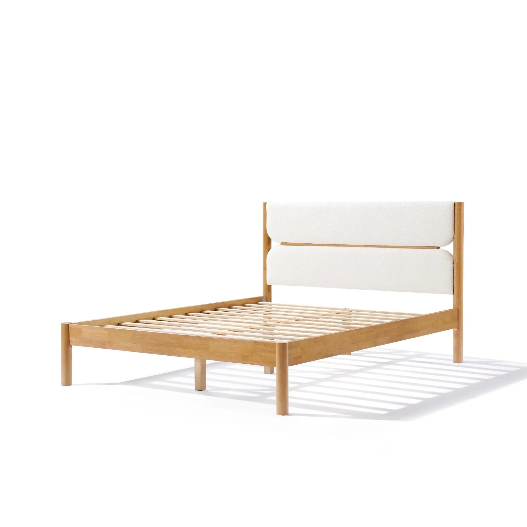 A solid wood bed frame exudes modern sophistication, featuring a cushioned headboard in luxurious white boucle fabric and a slatted base, beautifully set against a plain white background.