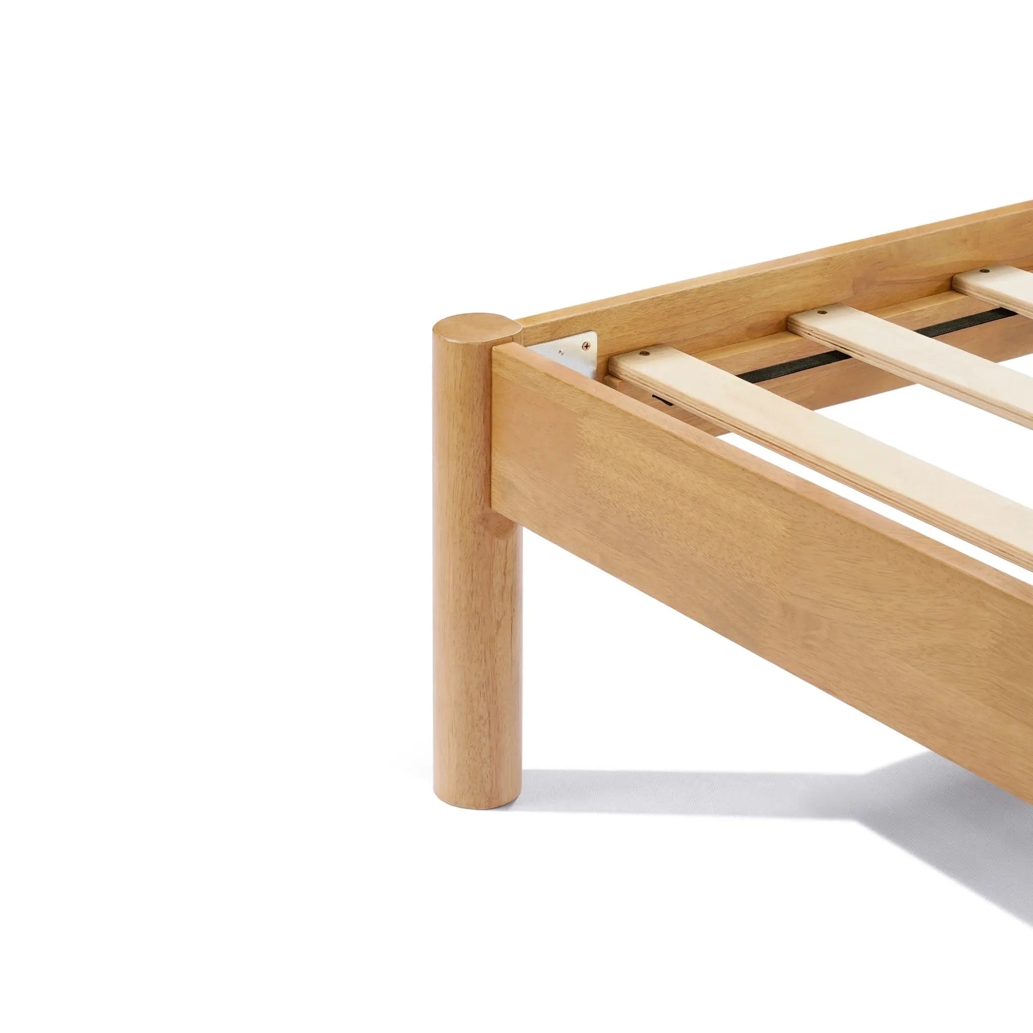 Close-up of a solid wood bed frame corner with slats visible, exuding modern sophistication.